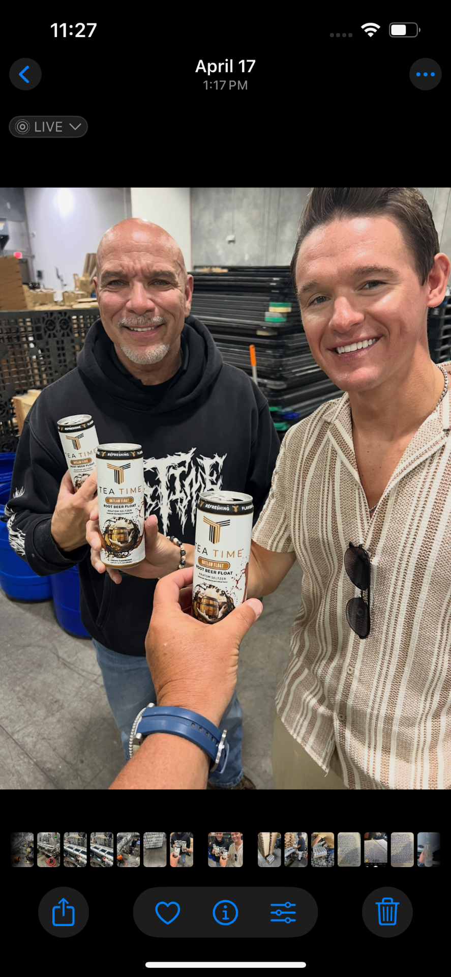 Gray Gaulding and Steve Rivero holding Tea Time cans inside a warehouse.